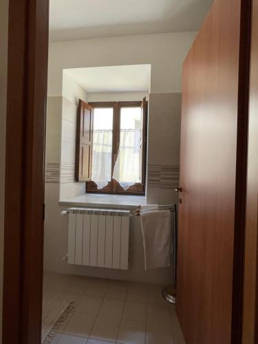 a bathroom with a window and a radiator at Casa di Adele in Brittoli