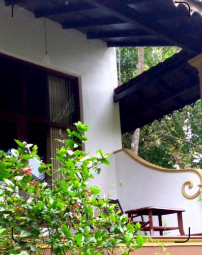 a bench sitting on the side of a house at Serenity Sigiri Resort in Sigiriya