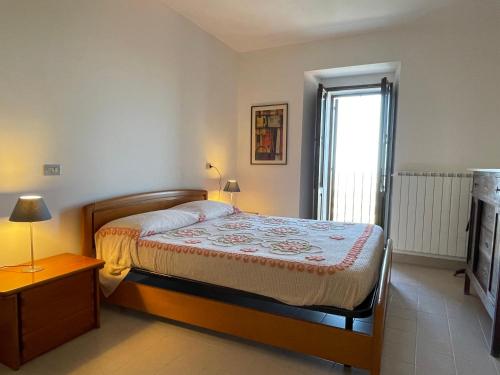 a small bedroom with a bed and a window at Casa di Adele in Brittoli