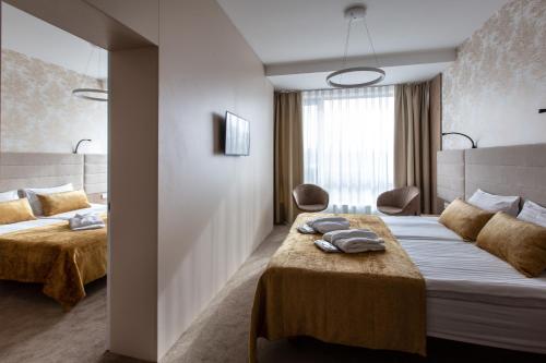 Un ou plusieurs lits dans un hébergement de l'établissement Grand SPA Lietuva Hotel Lietuva