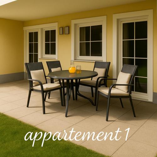 a black table and chairs on a patio at Appartementhaus Flattach Goritschnig in Flattach