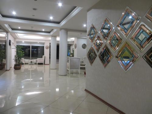 a lobby with a wall with paintings on it at Ozilhan Hotel in Ankara