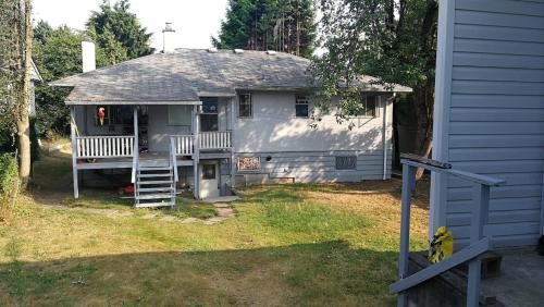 a house with two white benches in the yard at Burnaby house by New Westminster in Burnaby