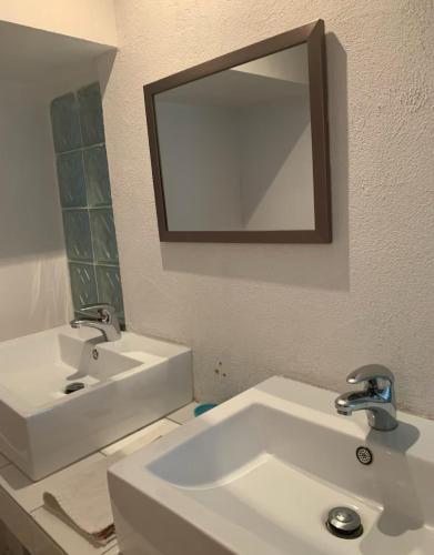 a bathroom with a white sink and a mirror at Hermoso Loft espectacular vista BosquesdelasLomas in Mexico City