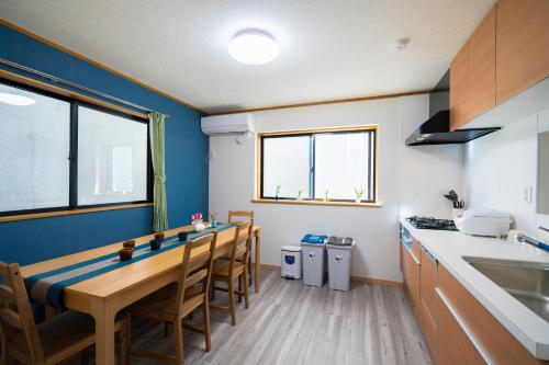 a kitchen with a table and some chairs in it at 風花Fuka民泊大森本町 in Tokyo