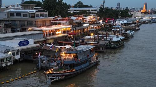 a group of boats docked at a dock in the water at Sabai Sabai Liveaboard Bangkok in Bangkok
