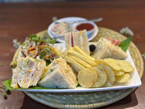 a plate of food with sandwiches and chips and dip at Lumbini Five Elements Hotel in Lumbini
