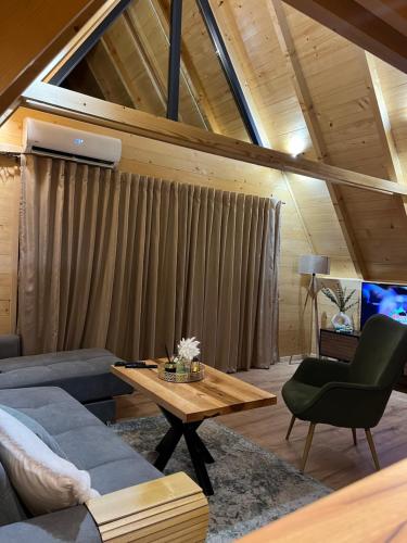 a living room with a couch and a table at Vila Jezero-Jajce in Jezero