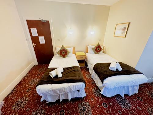 a hotel room with two beds in a room at Station Hotel Portsoy in Portsoy