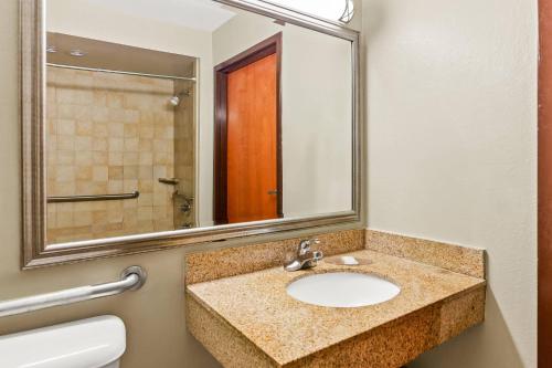 a bathroom with a sink and a mirror at Econo Lodge Mt Hope - Beckley in Mount Hope