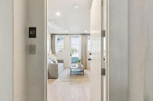 a hallway leading to a living room with a couch at Casa Riviera - Boutique Apartments in Downtown Santa Barbara in Santa Barbara