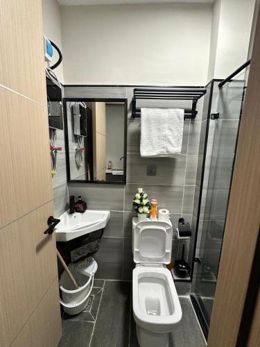 a small bathroom with a toilet and a sink at Roly Studio Apartment Near Jkia & Sgr with Swimming pool & Gym in Nairobi