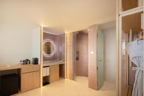 a bathroom with a shower and a sink at U Hua Hin in Cha Am