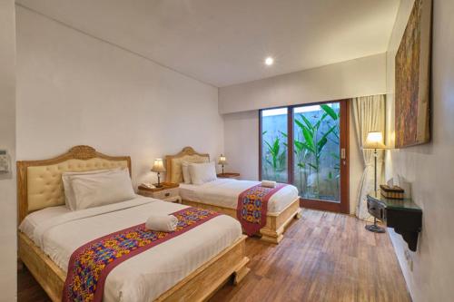 Ένα ή περισσότερα κρεβάτια σε δωμάτιο στο Miko Villas Ubud