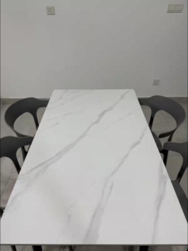 a white piece of paper sitting on top of a table at Astetica Residence in Serdang