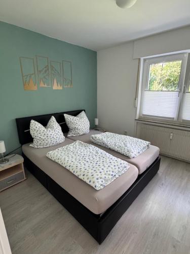 Postel nebo postele na pokoji v ubytování Ferienwohnung am Waldesrand