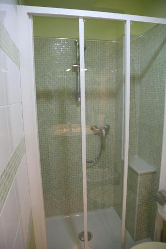 a glass shower in a bathroom with a toilet at Villa Manno in Barcellona-Pozzo di Gotto