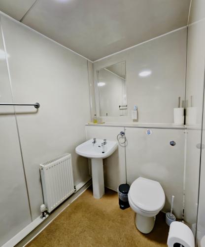 a bathroom with a white toilet and a sink at Station Hotel Portsoy in Portsoy