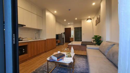 a living room with a couch and a table at The West Lake Serenity'N Homestay Ha Noi 462 in Hanoi