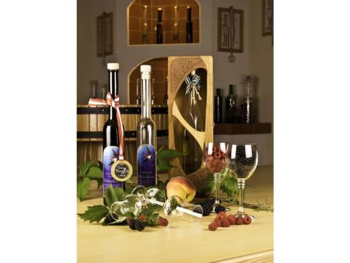 a table with wine bottles and glasses on it at Apartment in St Stefan im Rosental in Gigging