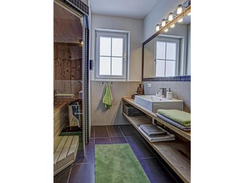 a bathroom with a sink and a mirror at Apartment in St Stefan im Rosental in Gigging