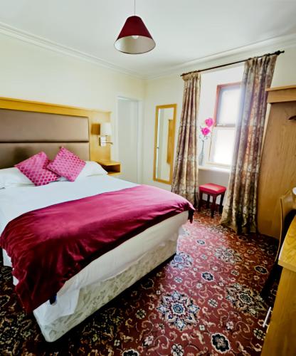 a hotel room with a bed and a window at Station Hotel Portsoy in Portsoy