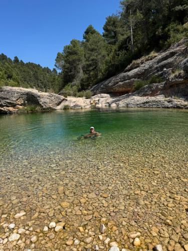 a man swimming in a body of water at Mas del Bot in Valderrobres