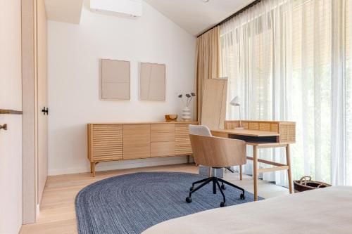 a bedroom with a desk and a bed and a window at Modern Luxury Apartment in Nida I 2BR Apartmen I Terrace I Cᴏʜᴏsᴛ in Nida