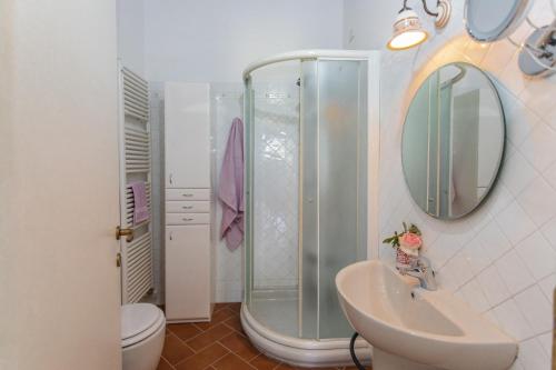 a bathroom with a shower and a sink at LA COLLINA DEGLI ULIVI 8&2, Emma Villas in Montefalco