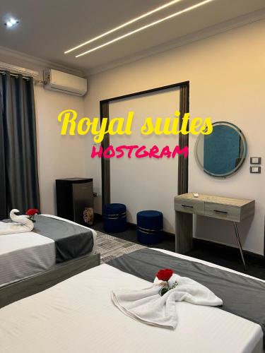 a hotel room with two beds and a royal suites restroom at Garden City Suites EL Tahrir in Cairo