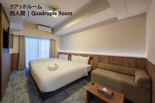 a hotel room with a bed and a couch at Apartment Hotel 11 Nippombashi in Osaka