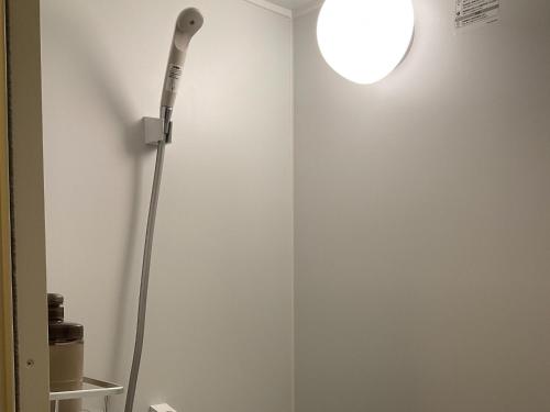 a lamp in a room with a white wall at Hotel Morimotoya Itano - Vacation STAY 05558v in Kamiita