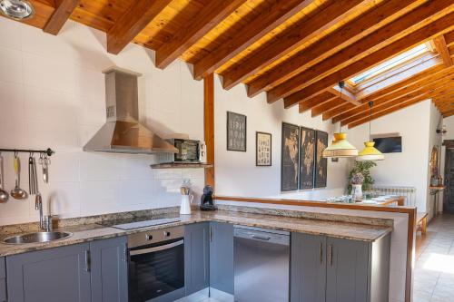 a kitchen with blue cabinets and a sink at El currillo preciosa casa rural al lado cabarceno in Argomilla