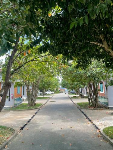 a tree lined street in a park with houses at Nutchana Hill Boutique Hotel in Ban Thung Ri