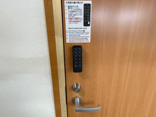 a remote control on a door with a sign on it at Hotel Morimotoya Itano - Vacation STAY 05548v in Kamiita