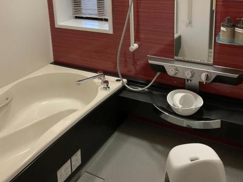 a bathroom with a bath tub and a toilet at Hotel Morimotoya Itano - Vacation STAY 05548v in Kamiita