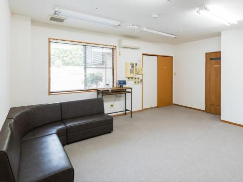 a living room with a couch and a window at Hotel Morimotoya Itano - Vacation STAY 05548v in Kamiita