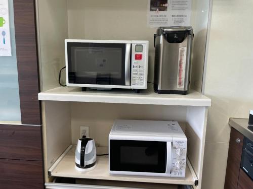 a microwave and a coffeemaker sitting on a shelf at Hotel Morimotoya Itano - Vacation STAY 05548v in Kamiita