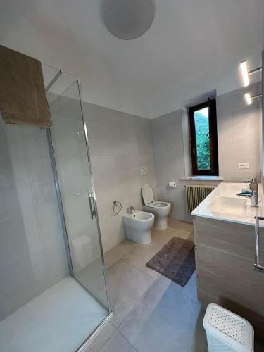 a bathroom with a shower and a toilet and a sink at Affittacamere Tarvisio in Tarvisio