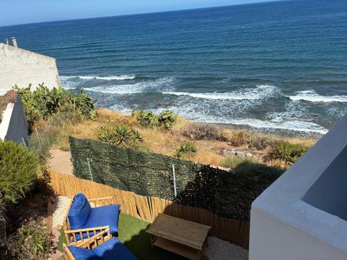 a balcony with chairs and a table and the ocean at La Medusa in La Ciaccia