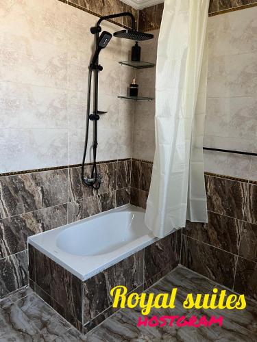 a bath tub in a bathroom with a shower at Garden City Suites EL Tahrir in Cairo