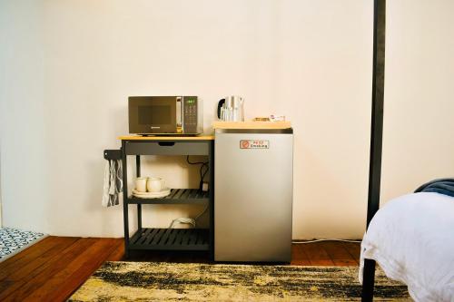 a small refrigerator next to a table with a microwave at The Breakpoint in Beaufort West