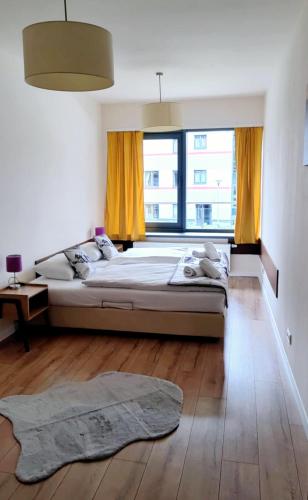 a bedroom with a large bed and a large window at Szklane Domy in Zakopane