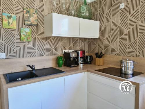 a kitchen with a sink and a counter top at Les Petites Fontenelles in Montjean