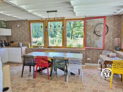 a kitchen with a table with colorful chairs at Les Petites Fontenelles in Montjean