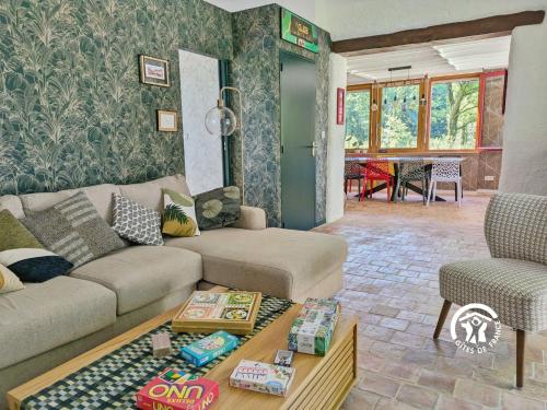 a living room with a couch and a table at Les Petites Fontenelles in Montjean