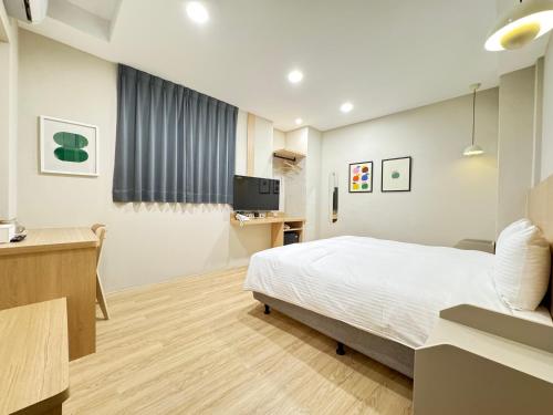 Un ou plusieurs lits dans un hébergement de l'établissement Yoshi Hotel - Tainan Sinmei Branch