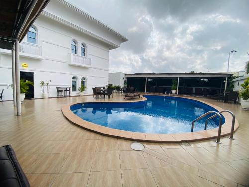 a large swimming pool in front of a building at PRESKEN WHITE HOUSE in Lagos