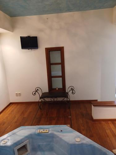 a room with a bed and a mirror and a chair at Apartment with a garden, BBQ, swimming pool and jacuzzi in Drafí