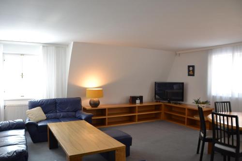 a living room with a couch and a tv at Apartmány Holiday Pec in Pec pod Sněžkou
